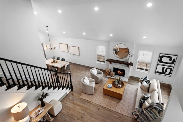 28166 Camellia Ct, Laguna Niguel, CA 92677 - living area featuring wood finished floors, recessed lighting, a notable chandelier, and a brick fireplace