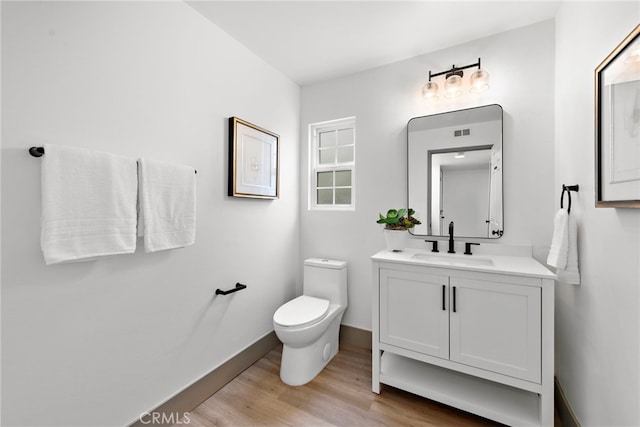 28166 Camellia Ct, Laguna Niguel, CA 92677 - half bath with wood finished floors, toilet, vanity, baseboards, and visible vents