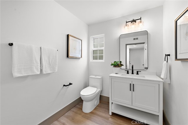 28166 Camellia Ct, Laguna Niguel, CA 92677 - half bathroom featuring vanity, wood finished floors, toilet, and baseboards