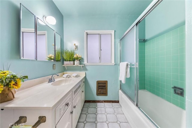bathroom with combined bath / shower with glass door, tile patterned flooring, vanity, and heating unit