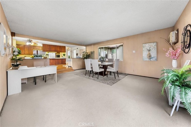 carpeted dining space with ceiling fan
