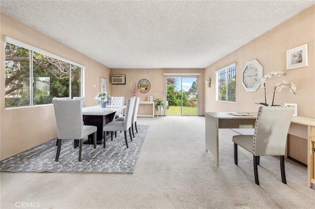 dining area featuring carpet floors, a textured ceiling, and a wall mounted air conditioner