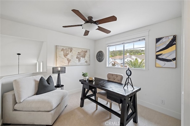 office space featuring ceiling fan, light carpet, and baseboards