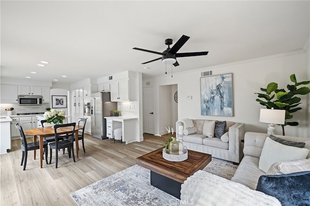 living area featuring recessed lighting, light wood-style floors, ceiling fan, visible vents, and crown molding