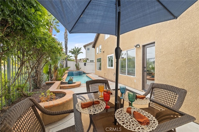 view of patio with a pool with connected hot tub and a fenced backyard