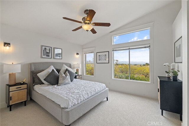 bedroom with light carpet, multiple windows, and vaulted ceiling