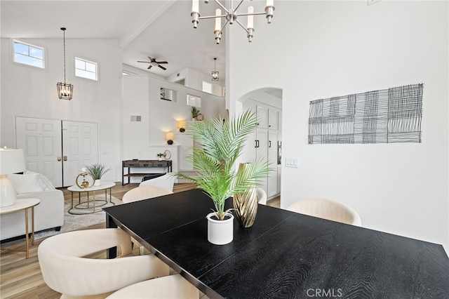 26 Apache Dr, Trabuco Canyon, CA 92679 - dining area with high vaulted ceiling, arched walkways, a chandelier, wood finished floors, and a ceiling fan