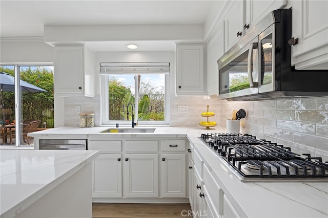 kitchen featuring white cabinetry, appliances with stainless steel finishes, and a sink