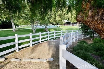 view of gate with fence and a yard