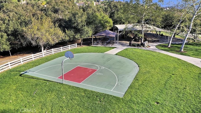 view of sport court featuring fence, a gazebo, basketball hoop, and a lawn