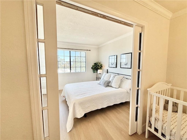 bedroom featuring wood finished floors and crown molding