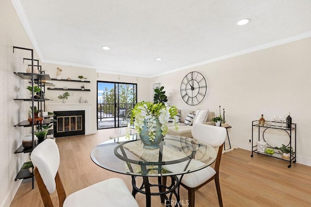 2599 Walnut Ave, Unit Signal Hill, CA 90755 - dining room with wood finished floors, a glass covered fireplace, crown molding, baseboards, and recessed lighting