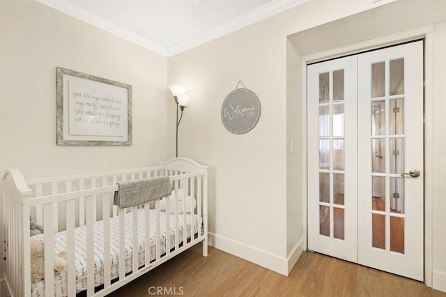 2599 Walnut Ave, Unit Signal Hill, CA 90755 - bedroom featuring wood finished floors, ornamental molding, baseboards, french doors, and a nursery area