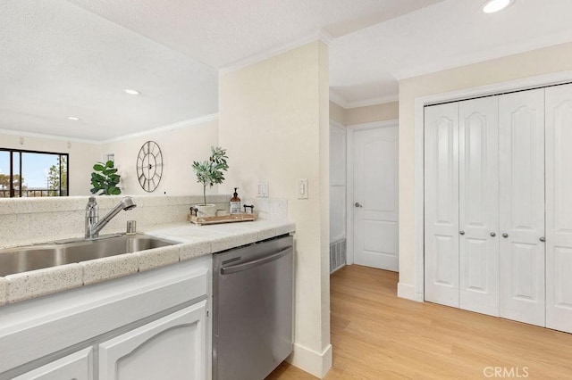 2599 Walnut Ave, Unit Signal Hill, CA 90755 - kitchen with stainless steel dishwasher, a sink, crown molding, light wood-style flooring, and light countertops