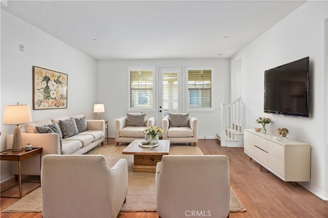 3240 S Westmont Ln Unit 5, Ontario, CA 91761 - living area featuring stairway, light wood finished floors, and baseboards