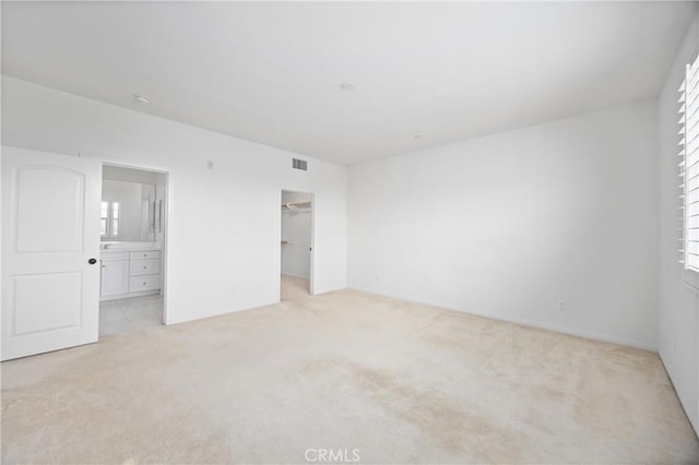 3240 S Westmont Ln Unit 5, Ontario, CA 91761 - unfurnished bedroom with carpet, a spacious closet, and connected bathroom