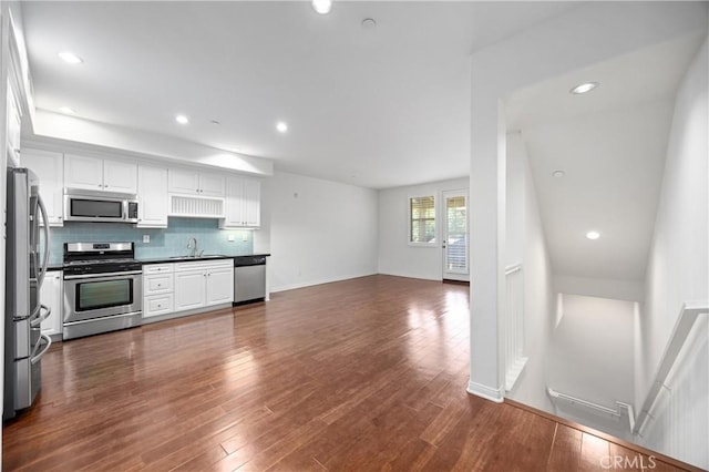3240 S Westmont Ln Unit 5, Ontario, CA 91761 - kitchen featuring a sink, tasteful backsplash, white cabinetry, appliances with stainless steel finishes, and open floor plan