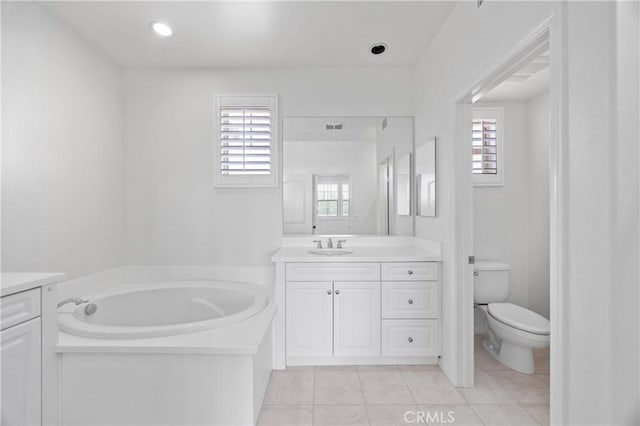 3240 S Westmont Ln Unit 5, Ontario, CA 91761 - bathroom with vanity, a garden tub, toilet, and tile patterned flooring