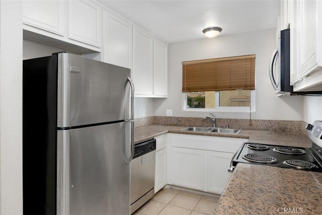 kitchen featuring stainless steel appliances, a sink, white cabinetry, light countertops, and light tile patterned floors