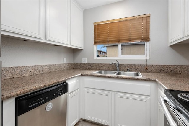 kitchen featuring light countertops, appliances with stainless steel finishes, white cabinetry, and a sink