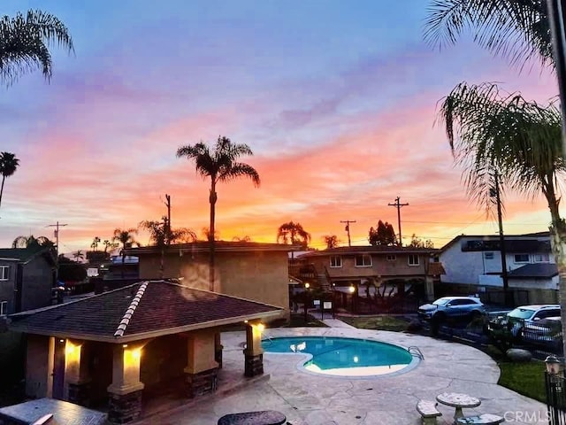 outdoor pool with a patio area