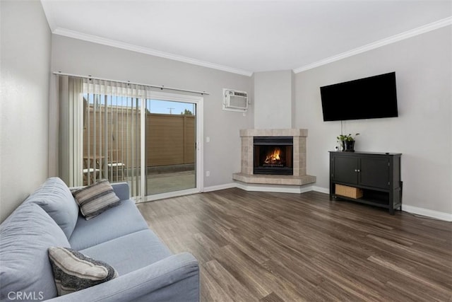 living area featuring a wall mounted AC, wood finished floors, crown molding, and baseboards