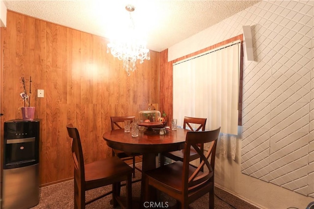 1310 W Lambert Rd Unit 180, La Habra, CA 90631 - carpeted dining space with wood walls, a textured ceiling, and a notable chandelier