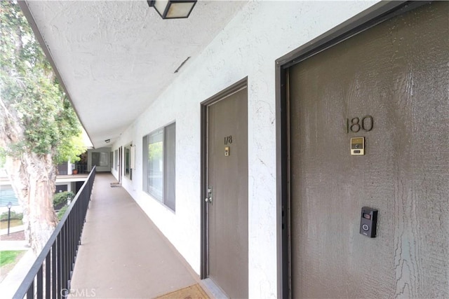 1310 W Lambert Rd Unit 180, La Habra, CA 90631 - view of exterior entry featuring a balcony and stucco siding