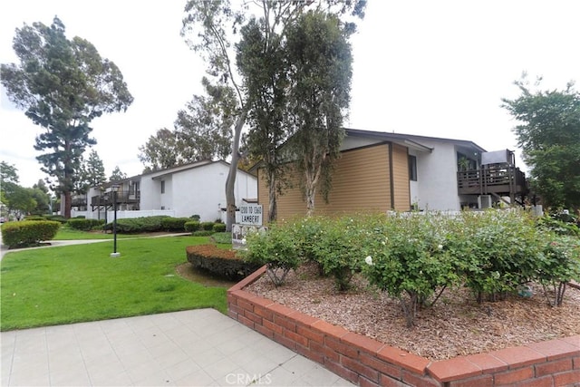 1310 W Lambert Rd Unit 180, La Habra, CA 90631 - view of property exterior with a lawn and stucco siding