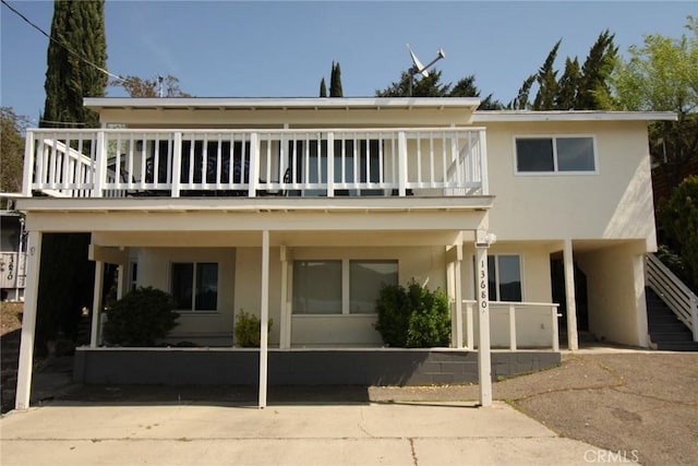 view of front of property with stucco siding and stairway