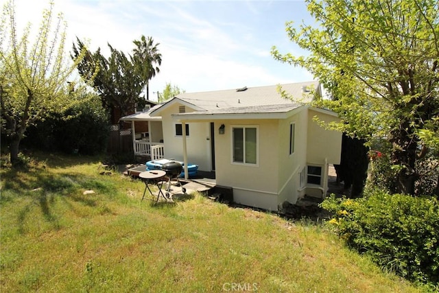 rear view of property with stucco siding
