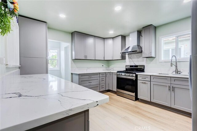 2315 Hillview Ave, Monterey Park, CA 91754 - kitchen with wall chimney range hood, gray cabinets, stainless steel gas range oven, and recessed lighting