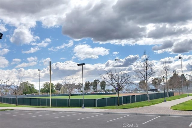 uncovered parking lot featuring fence