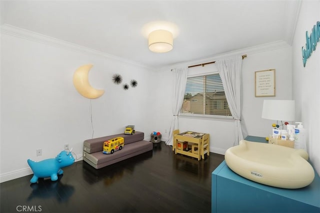 playroom featuring baseboards, ornamental molding, and wood finished floors