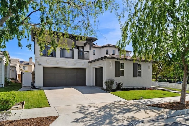 mediterranean / spanish-style house with an attached garage, a front lawn, stucco siding, and a balcony
