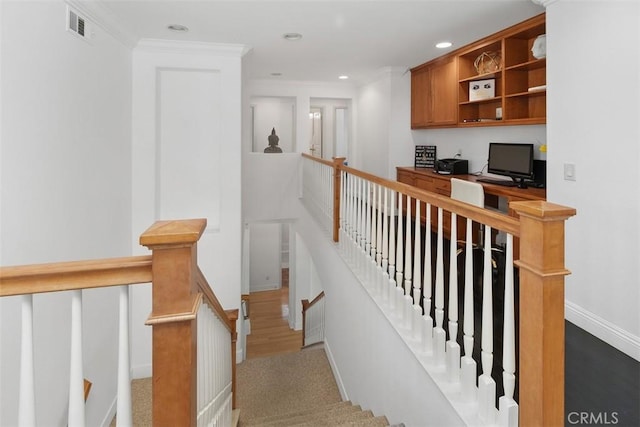 stairs featuring visible vents, wood finished floors, baseboards, ornamental molding, and recessed lighting