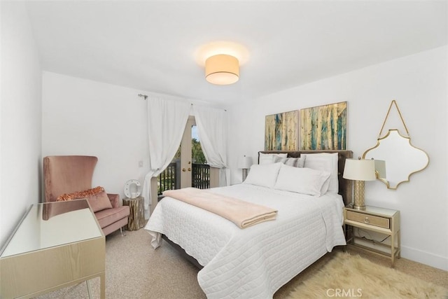 bedroom with access to outside and baseboards