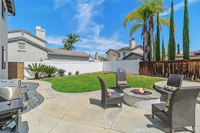 view of patio with a fenced backyard, grilling area, and an outdoor fire pit