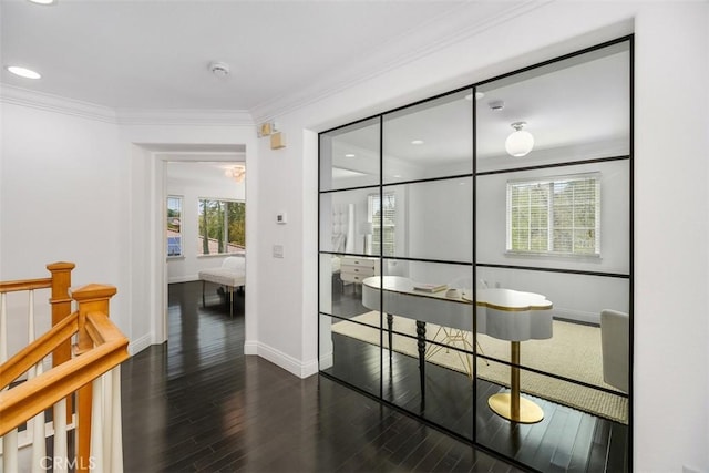 interior space featuring baseboards, ornamental molding, dark wood-type flooring, and recessed lighting