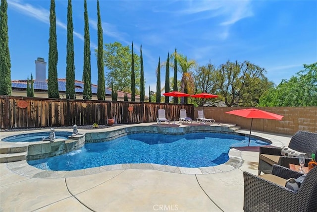 view of swimming pool featuring a patio, a fenced backyard, and a pool with connected hot tub