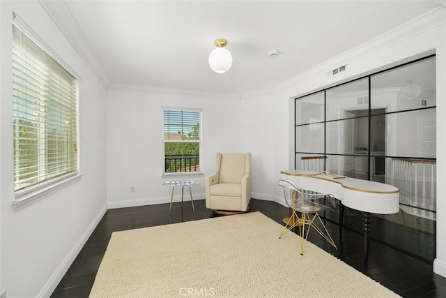 sitting room with dark wood-type flooring, ornamental molding, baseboards, and visible vents