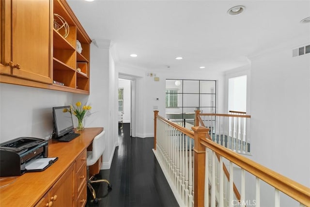 corridor with crown molding, dark wood finished floors, recessed lighting, baseboards, and visible vents