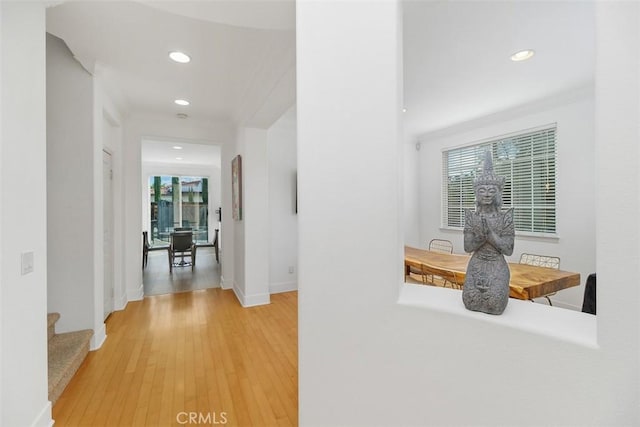 corridor featuring recessed lighting, light wood-style floors, and baseboards