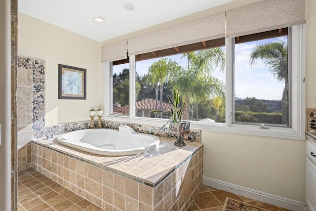bathroom with a bath, baseboards, tile patterned floors, and recessed lighting