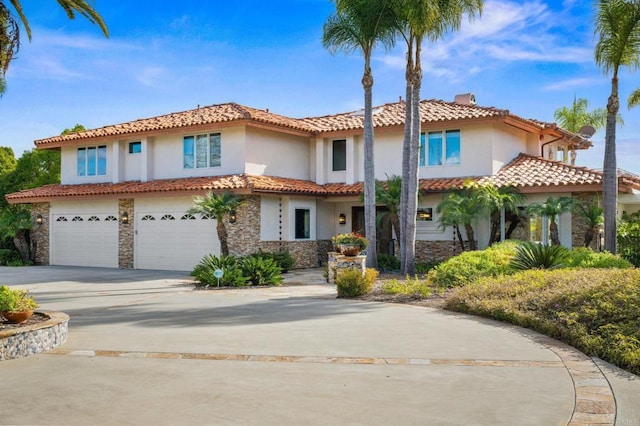 mediterranean / spanish house with stone siding, a tiled roof, and stucco siding