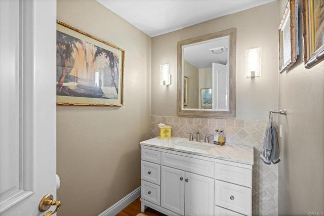 bathroom featuring backsplash, vanity, and visible vents