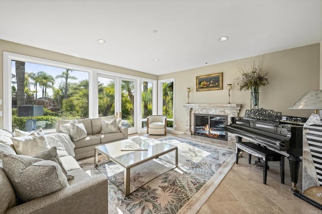 living room with a fireplace, recessed lighting, and a healthy amount of sunlight