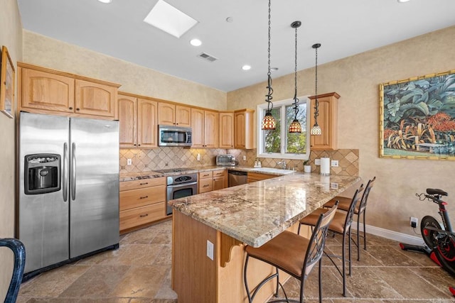 1072 Wiegand, Encinitas, CA 92024 - kitchen featuring stainless steel appliances, a peninsula, light stone countertops, a breakfast bar, and stone tile floors