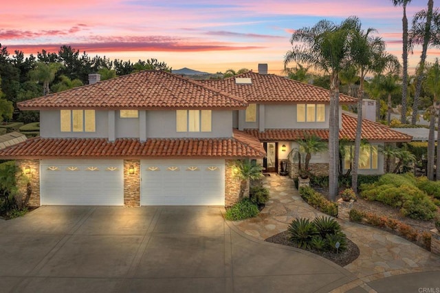 1072 Wiegand, Encinitas, CA 92024 - mediterranean / spanish-style house featuring driveway, stone siding, an attached garage, a tile roof, and stucco siding