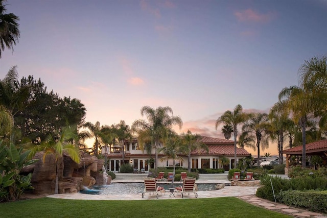 1072 Wiegand, Encinitas, CA 92024 - back of property at dusk with a lawn and a patio area